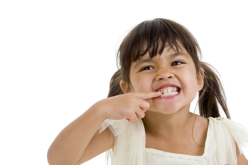 A child touching her teeth 2