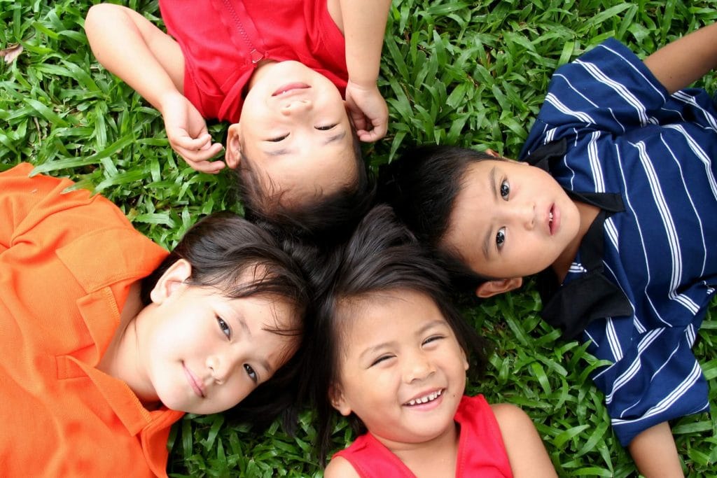 Kids lying on the grass