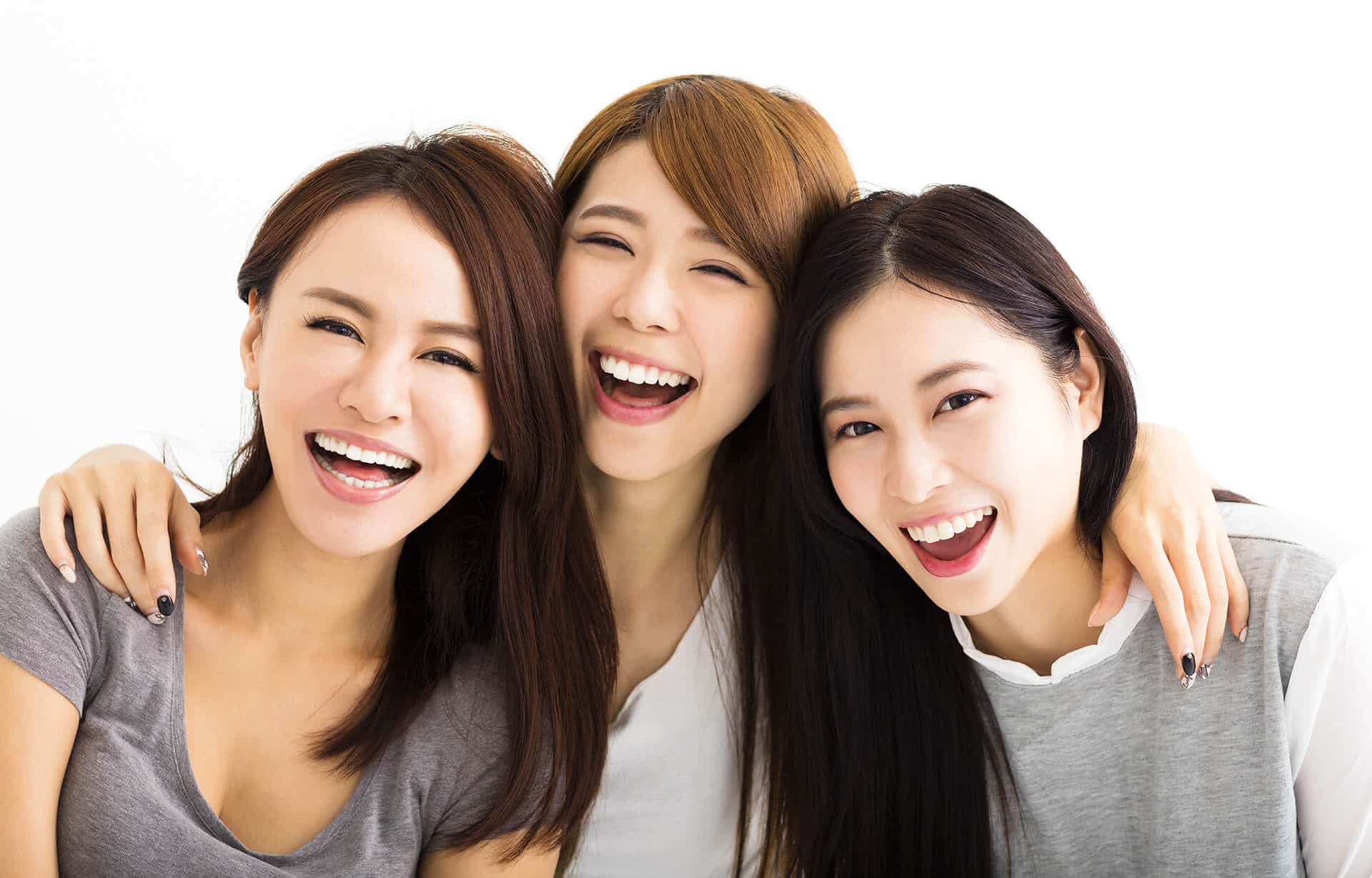 Ladies smiling with clear braces