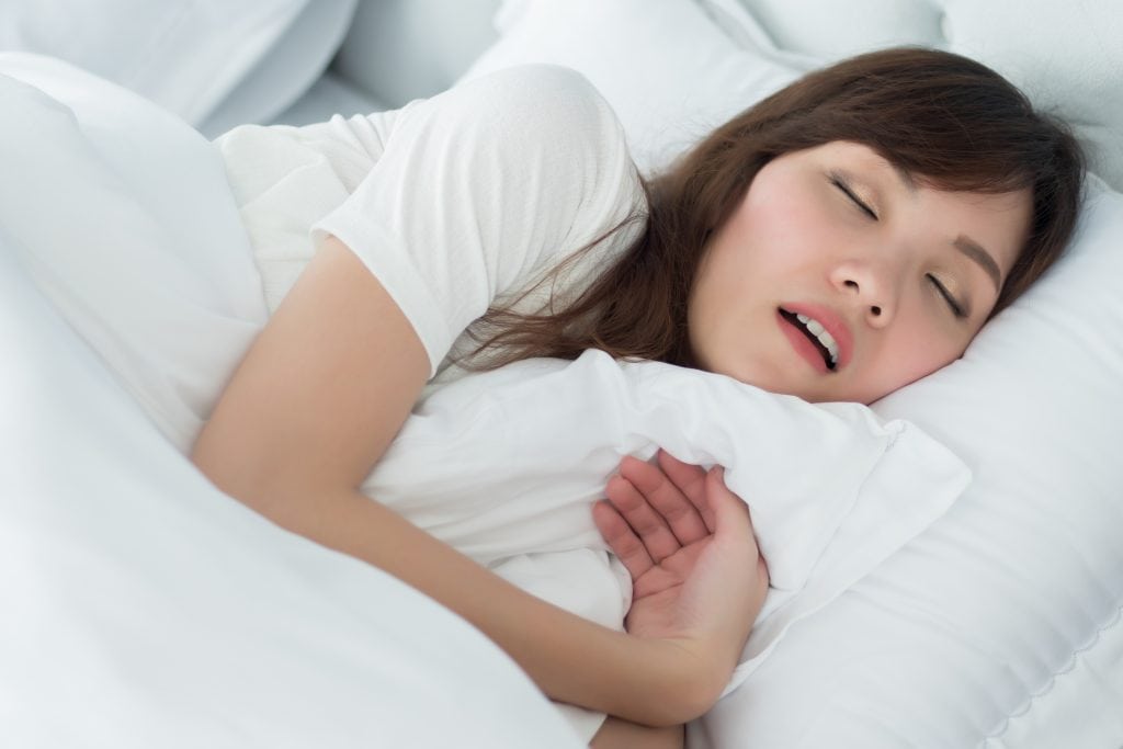 woman gasping for air while sleeping