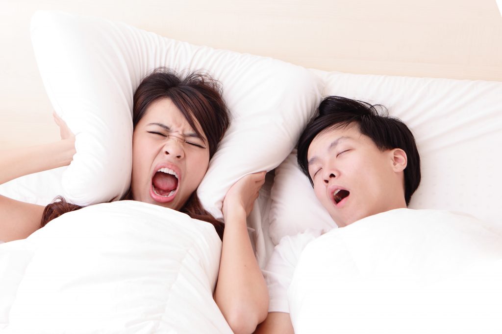 man snoring at night and disturbing his partner