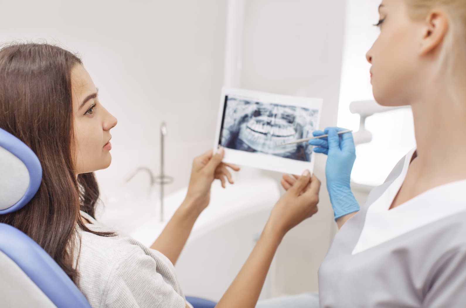 a dentist indicating the teeth for inlays and onlays